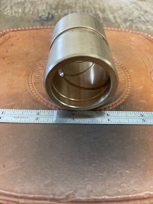 3364 GASO Bronze material connecting rod bushings, looking through it longways to see the machined oil grooves. 